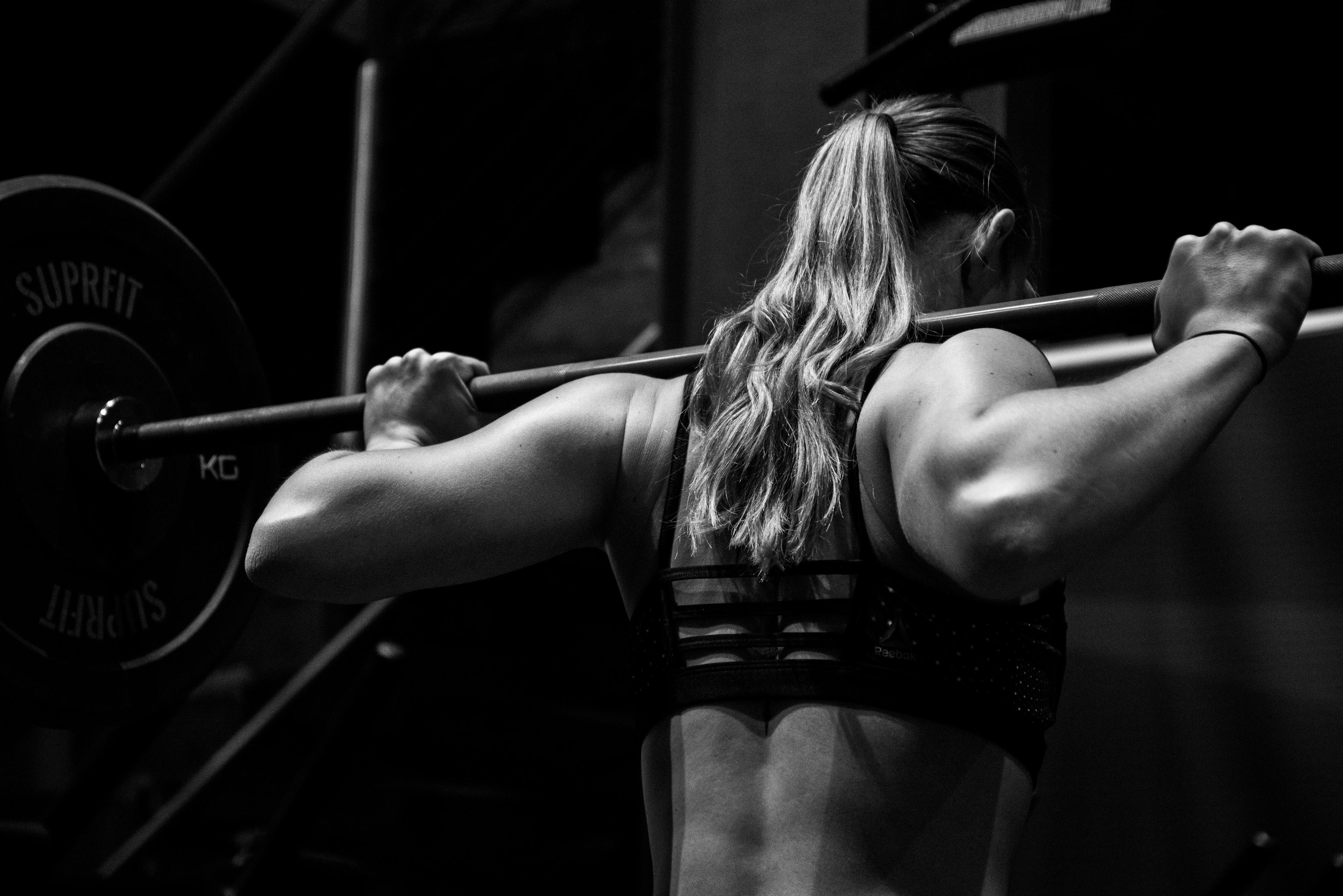 Trainer helping client